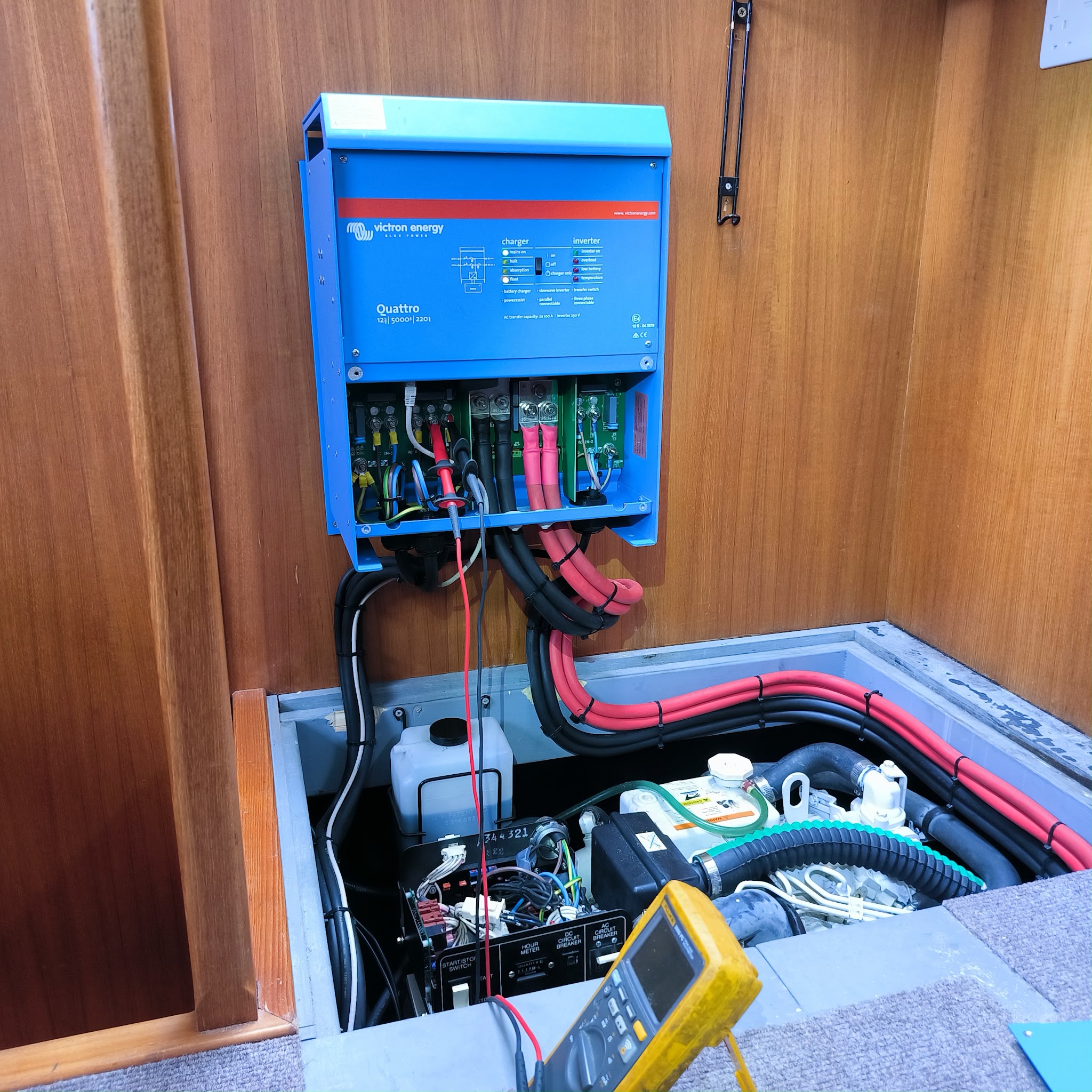 Victron inverter and charger mounted in a boat with the engine bay below